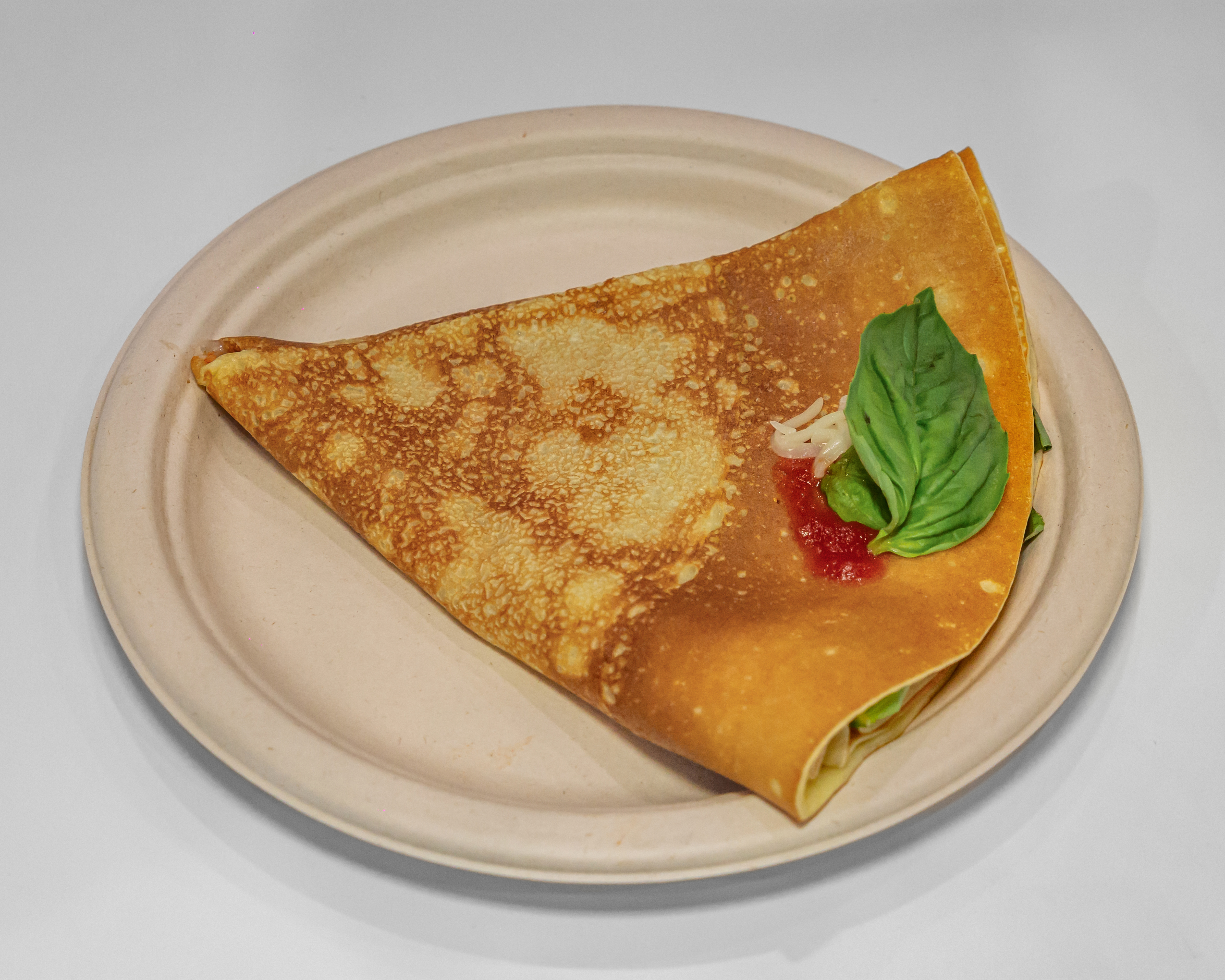 Strawberry crepe with caramel syrup and mint