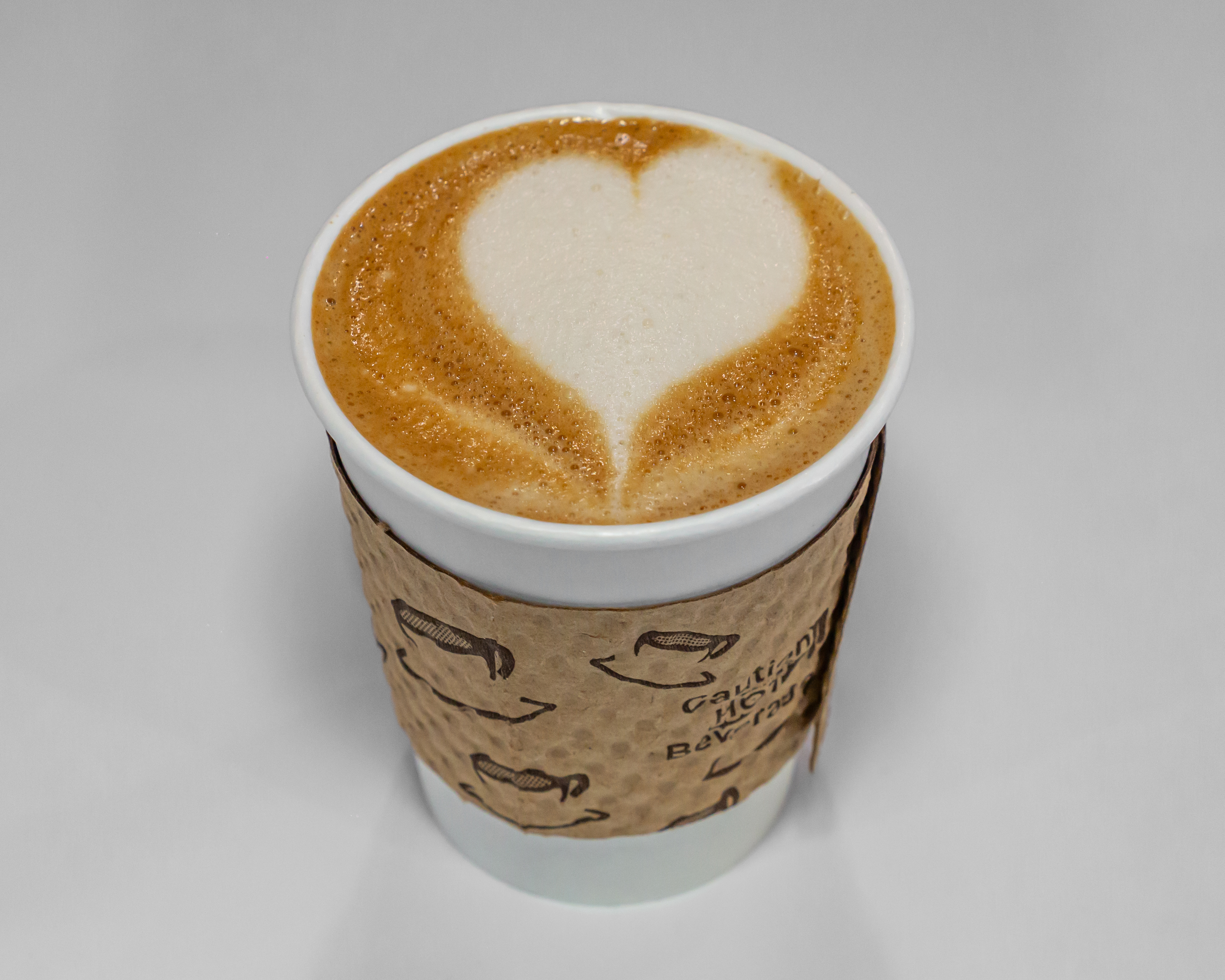 Latte with art in a glass cup